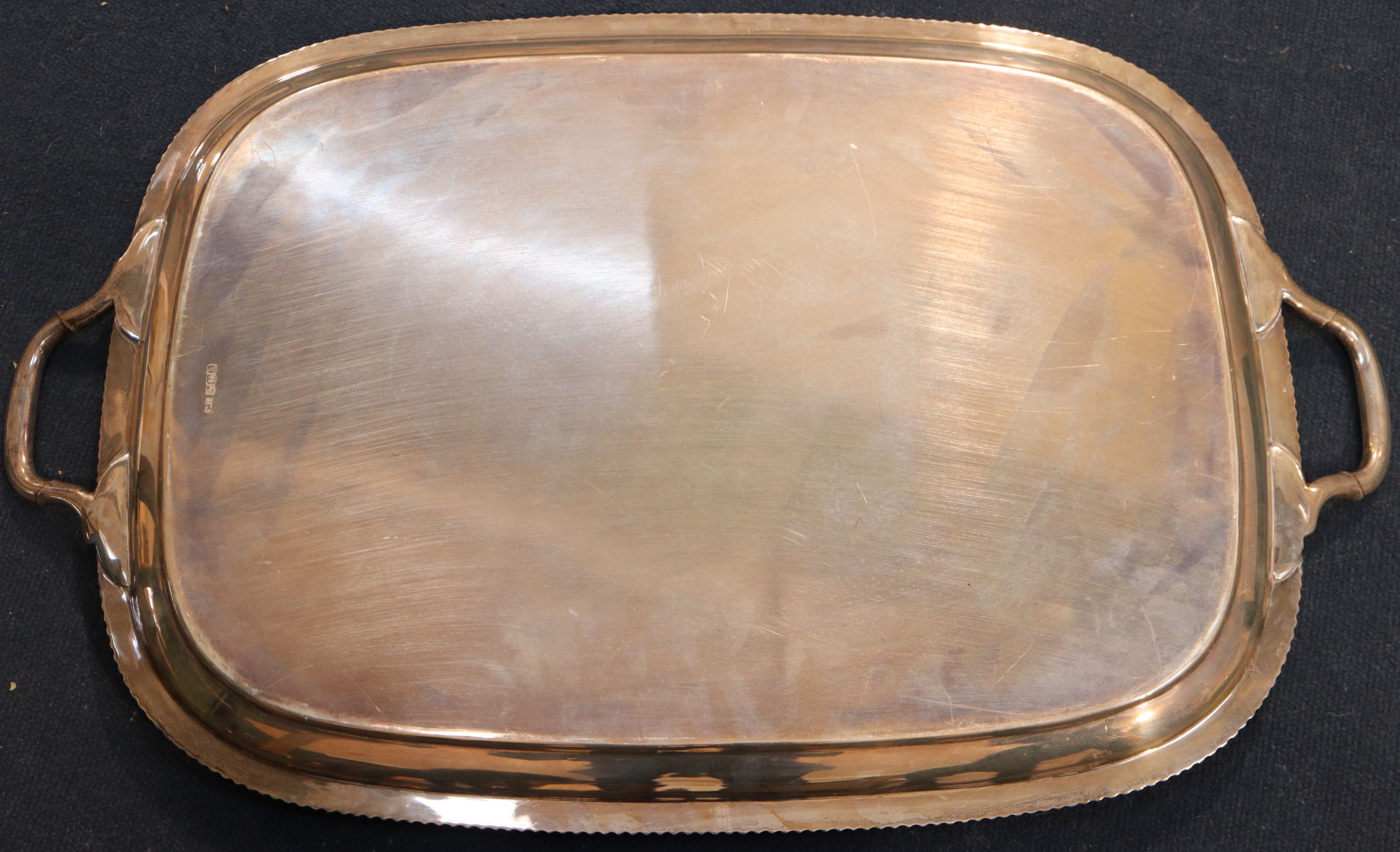 A George V silver two handled tea tray, 64.7cm over handles, 98oz.